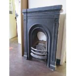 A Victorian cast iron fire surround with arched fireplace, 98cm high 70cm wide and a brass fender (