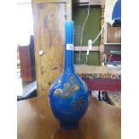 A Japanese blue glaze vase, with long neck and remnants of a floral design, 41cm high