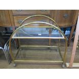 An Art Deco style brass tea trolley with glass shelves and later castors 72cm high