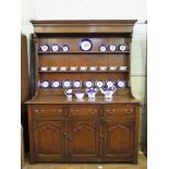 An 18th century style oak dresser and rack, the rack with three shelves over seven trinket