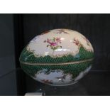 A Dresden box in the form of an egg, with floral painted decoration and green scale border, 18cm