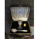 A cased child's silver egg cup and spoon