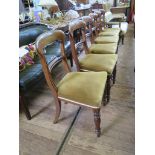 A set of six Victorian mahogany dining chairs, the open backs with overstuffed seats on turned