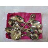 A collection of silver and white metal souvenir spoons