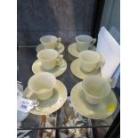 A set of six jade coffee cups and saucers, saucers 11cm diameter