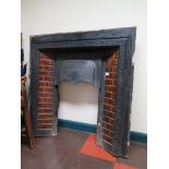 A Victorian cast iron fire surround with leaf decorated hood and brown glaze tiles, 96.5cm high,