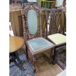 A Victorian carved oak hall chair, the oval upholstered vine carved back above turned fluted legs