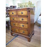 A reproduction crossbanded mahogany chest of drawers with two short and three long drawers, on