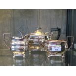 A three piece silver tea set standing on four ball feet, Sheffield 1961