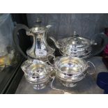 A four piece silver tea service, the tea pot and water jug having wooden handles and knops, marks