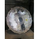 A round Victorian silver tray on four ball and claw feet having decorative border with bright cut