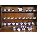 A 19th century floral decorated tea service with cobalt blue border and gilt swags, 37 pieces