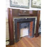 A 1920s mahogany mantelpiece, with inset shelf and moulded supports, 135cm wide