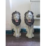 A pair of reconstituted stone and painted ornamental lions 50cm high (2)