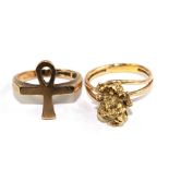 A gold colour metal ring, set with a small gold nugget and another