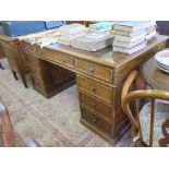 A mahogany pedestal desk, the leather inset top over three frieze drawers above pedestals each