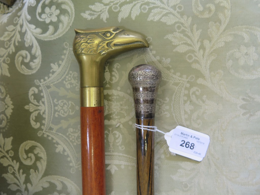 A silver topped cane and a 'tipple stick' with brass eagle form handle (2)
