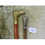 A silver topped cane and a 'tipple stick' with brass eagle form handle (2)
