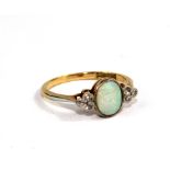 An 18 carat ring, set with central opal and diamond shoulders