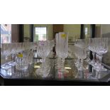 A set of matching drinking glasses, including six champagne flutes, six medium wine glasses, five