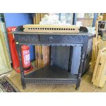 A Victorian ebonised corner table, carved with lunettes, the frieze drawer on turned supports and