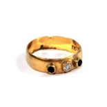 A diamond and sapphire three stone ring set in 22 carat gold