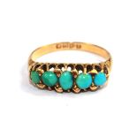 An 18 carat gold ring set with five turquoises