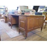 A 1920s oak Partners desk, the leather inset top over a central drawer flanked by three graduated
