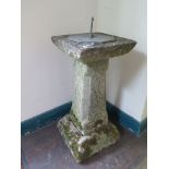 A reconstituted stone and metal sundial, with square tapering support 67cm high