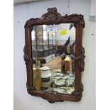 A mid Victorian mahogany mirror, the bevelled plate within a vine carved frame, 36cm x 24cm