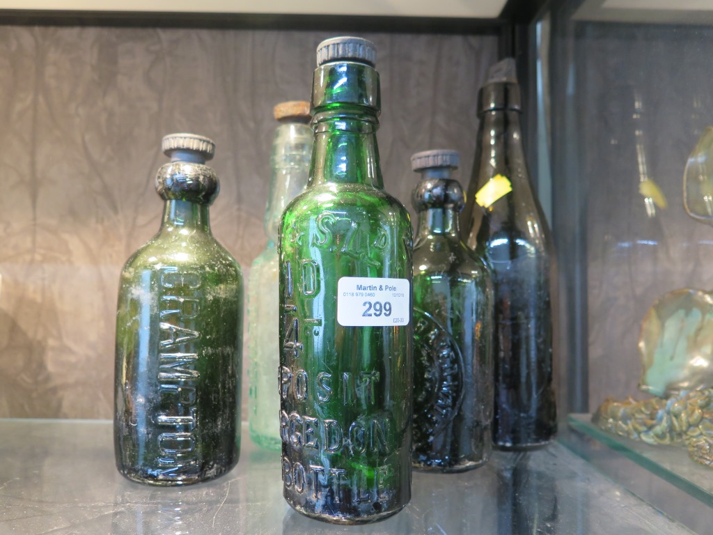 Five antique glass bottles with stoppers