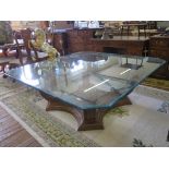A foliate scroll carved walnut centre table, with canted square glass top 152cm square, 57cm square