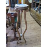 A pine tripod jardiniere stand, with lead lined inset top on shaped supports