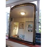 A Victorian ebonised and gilt wall mirror, with arched plate, 120cm x 96cm