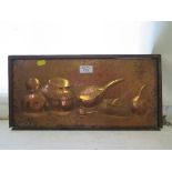 A copper repousse panel depicting gourds and vessels 20cm x 43cm