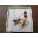 A silver and amber fly brooch and a silver and amber pair of earrings together with a silver and