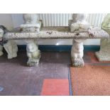 A reconstituted stone garden bench, the rectangular top on squirrel supports 110cm wide