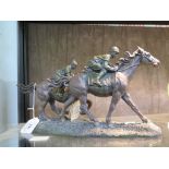 A Juliana collection bronze finish cast resin study of two jockeys racing, 17cm high