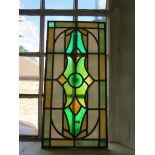 A green and cream leaded glass panel 69cm x 34cm