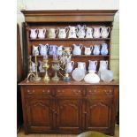 An 18th century style oak dresser and rack, the rack with three shelves over seven trinket