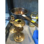 A brass trivet saucepan, with three legs and a pair of brass candlesticks (3)