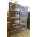 An oak stacking bookcase, the four compartments with glazed fall fronts, 88.5cm wide