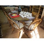 An Ercol dark elm oval dining table, on a pedestal base, 165cm x 121cm and a set of six dining