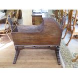 An early Victorian mahogany cradle, on ring turned supports and stretcher with bracket feet, 103cm