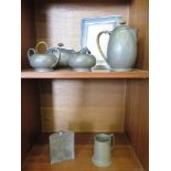 A Tudric Pewter four piece tea service with cane handles and hammered finish no. 01455, a photo