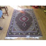 A Tabriz rug, with central red medallion black field and multiple spandrals all filled with flower