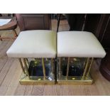 A pair of brass club fender stools, with leatherette upholstered seats on turned supports, 38cm