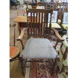 An Edwardian oak carver dining chair, with rail back and barley twist supports joined by turned