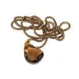 A smoky quartz pendant with 9 carat chain