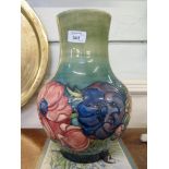 A large blue and green Moorcroft vase with floral decoration, painted initial and impressed marks